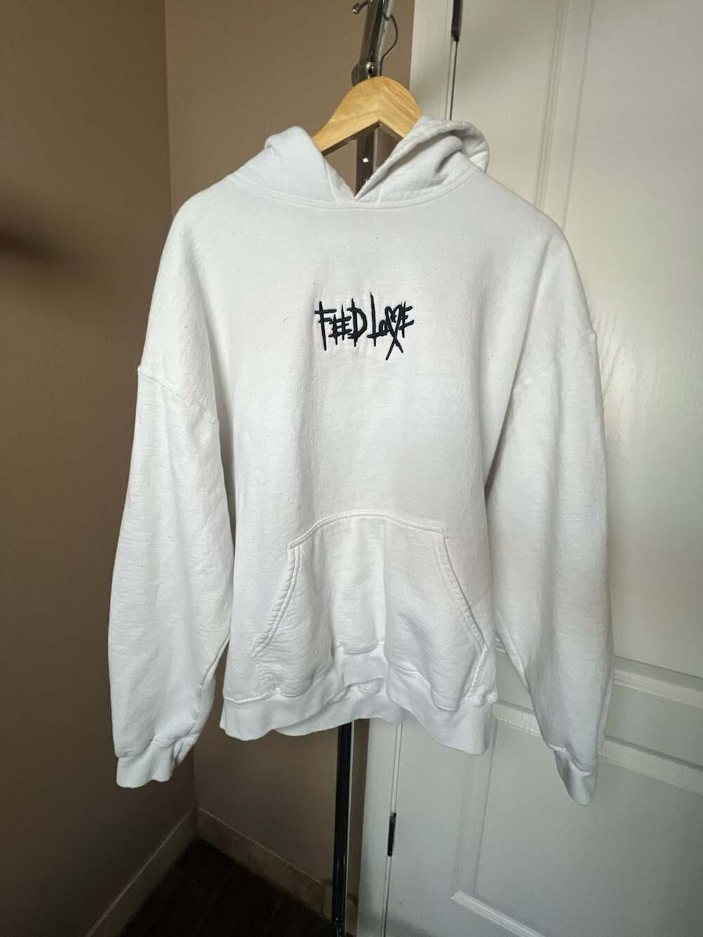 Feed Love White Embroidered Hoodie Love Changes Worlds Graphic